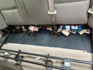 Trash under rear seat